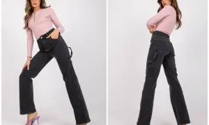Modelka w różowym topie i ciemnych jeansach straight. Co to znaczy? Proste nogawki, które nie opinają, ale też nie są za szerokie.